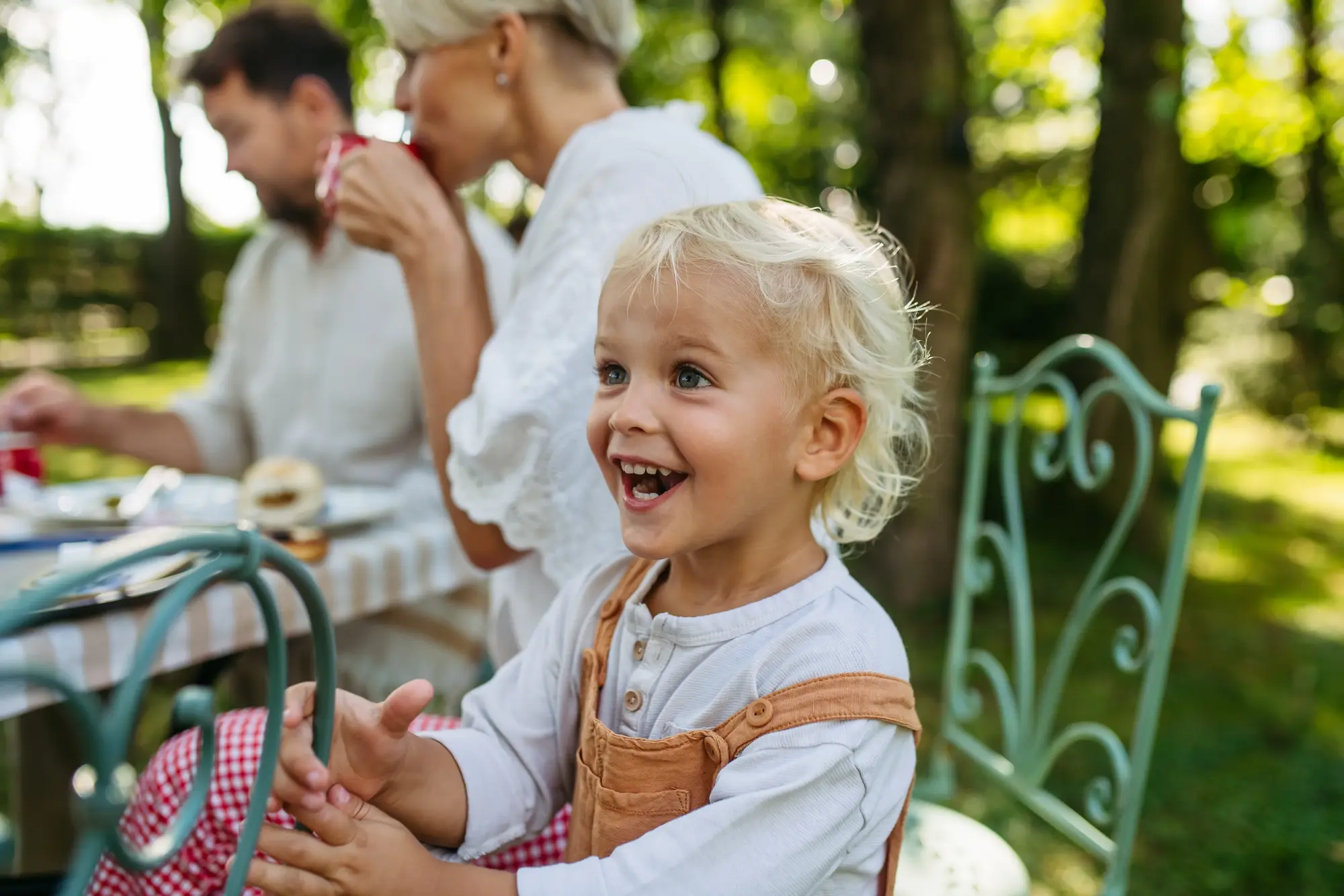 A family smiling together outdoors