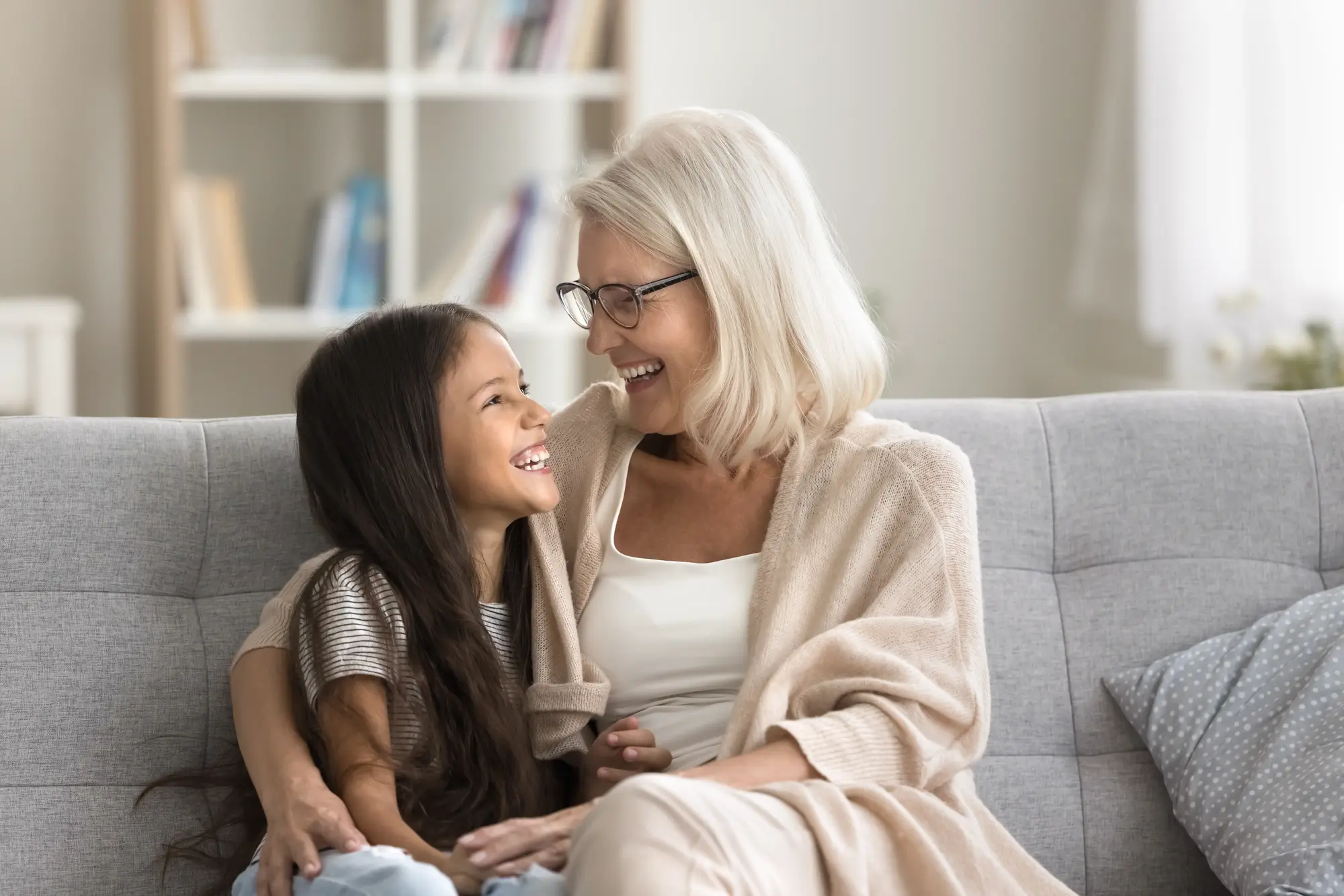 A grandmother and granddaughter relaxing together on the couch