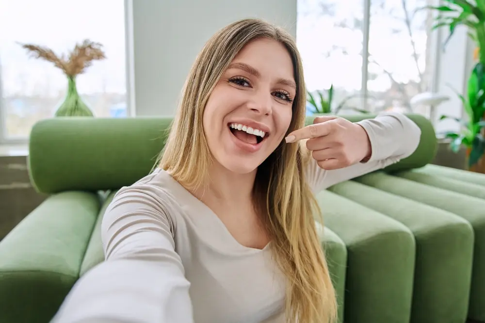 Smiling woman pointing to her teeth