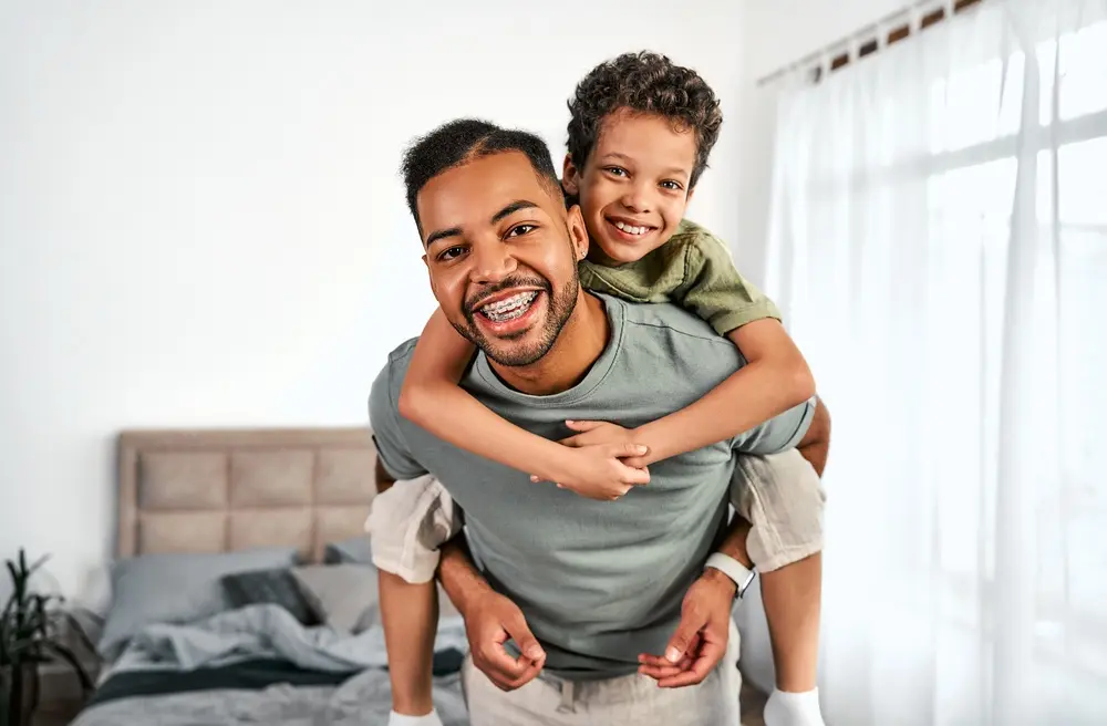 Smiling father giving his son a piggyback ride